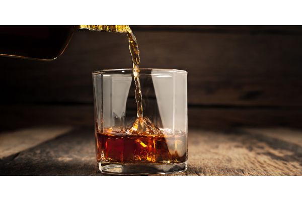 whiskey drink being poured